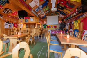 a restaurant with wooden tables and chairs and a screen at Hotel-Gasthaus "Krone" in Bötzingen