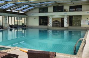 a large swimming pool in a building at Beach View Apartment in Shkorpilovtsi