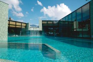 a building with a water fountain in front of it at Chalet les Ecureuils Apartment Penthouse Suite in Crésuz