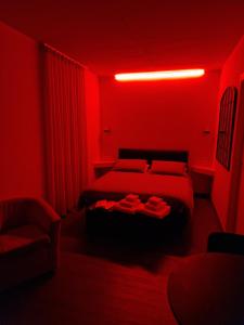 a red bedroom with a bed and a red light at Casa Antelami in Salsomaggiore Terme