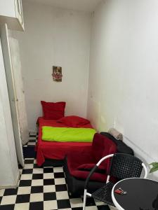 a bedroom with a red and green bed in a room at Manana House in Tbilisi City