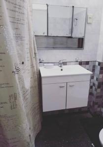 a bathroom with a sink and a shower curtain at Departamento amplio, cerca de todo in Guaymallen +16 photos