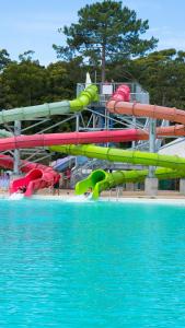 a water park with a water slide next to a pool at Solanas Green Park Spa & Resort in Punta del Este