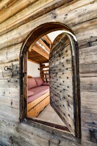 an archway in a wooden room with a bed at Mazot De La Marcelline in Saint-Gervais-les-Bains