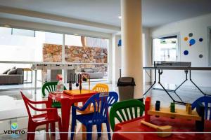 a dining room with a red table and chairs at VENETO VILLAGE MR in Villa Parque Siquiman
