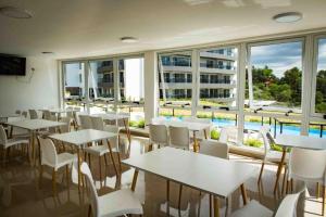a restaurant with tables and chairs and a large window at VENETO VILLAGE MR in Villa Parque Siquiman