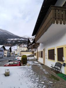 a snow covered street in a town with buildings at A Casa Dei - Appartamento Colle Isarco in Colle Isarco