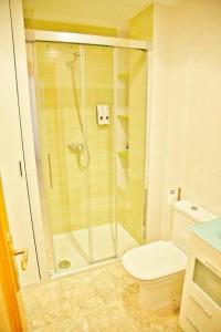 a bathroom with a shower and a toilet at Apartamento Playa Xilxes in Xilxes