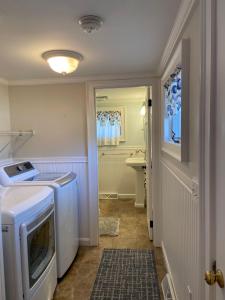 a laundry room with a washer and dryer in it at 19 Burton Avenue West Harwich - - Lobsta House in West Harwich +22 photos