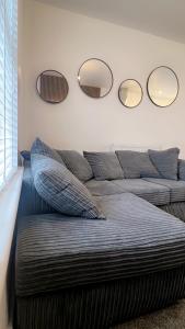 a bed with three mirrors on the wall at Modern 2 bed flat Southampton- Close to Central Station & Shops in Southampton