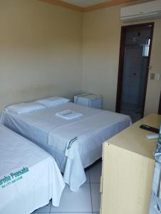 two beds in a hotel room with at Hotel Algaroba Anexo in Bom Jesus da Lapa