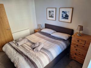 a bedroom with a bed with two towels on it at Ocean View in Campbeltown
