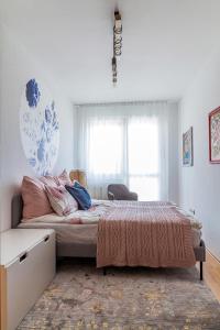 a bedroom with a bed and a window at Almere with FREE Parking in Budapest