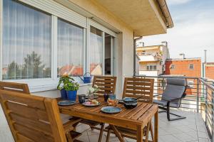 a wooden table on a balcony with a table and chairs at Almere with FREE Parking in Budapest