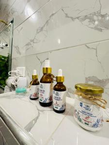 a bathroom sink with three bottles of hair oil at West Bank luxury villa in Luxor