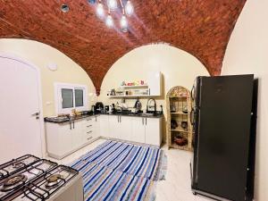 a kitchen with white counters and a brick ceiling at West Bank luxury villa in Luxor