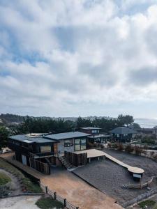a house with a roof with a bench on it at Punta Lobos Beachfront House, Taivarua in Pichilemu