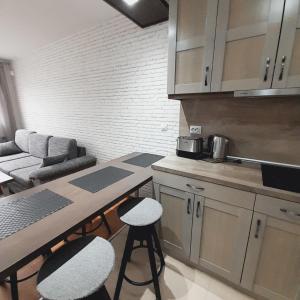 a kitchen with a table and stools in a room at VIP Apartments Belvedere with terrace K105 in Bansko