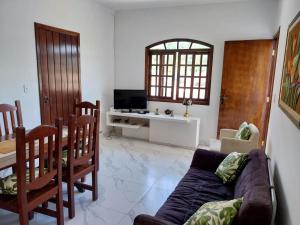 a living room with a couch and a table at +A apartamentos in São Sebastião