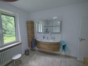 a bathroom with a tub and a sink and a window at Ferienhaus Heiligenmühle in Leinburg +29 photos