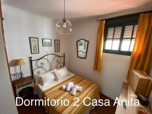 a bedroom with a bed and a window at Casa Rural Paz in Benarrabá