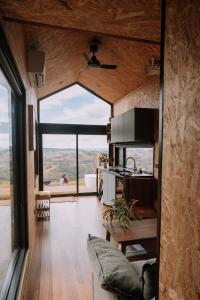 a kitchen and living room in a tiny house at Hilltop Off Grid Tiny House with Outdoor Bath 