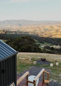 a view from the deck of a house with a view at Hilltop Off Grid Tiny House with Outdoor Bath 