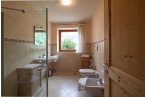 a bathroom with a sink and a toilet and a window at Messnerhof, Durnholz in Valdurna +12 photos