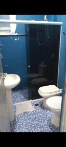 a bathroom with two toilets and a sink at Rua barata ribeiro 220 ipanema in Rio de Janeiro