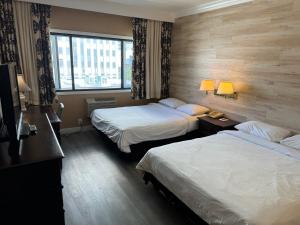 En eller flere senge i et værelse på Garden Suite Hotel and Resort + 18 billeder