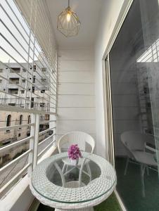 une table et des chaises sur un balcon avec une table et des fleurs dans l'établissement NK Homes - Serviced Apartments, à Hyderabad