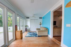 a living room with blue walls and a couch at Palm City Home with Pool and Florida Room - Near Golf in Stuart