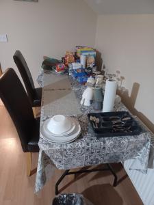 a table with a table cloth and plates on it at Country Haven eircode H54 AK31 in Galway