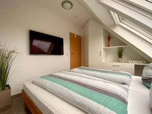 Ένα ή περισσότερα κρεβάτια σε δωμάτιο στο Dat Ferienhus Norddeich Ferienwohnung 6