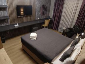 a hotel room with a bed and a flat screen tv at Nomad Hub Istanbul Residence in Istanbul