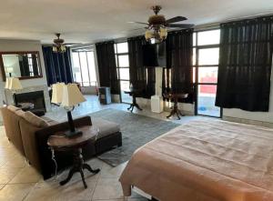 a living room with a bed and a couch at Penthouse TJ in Tijuana