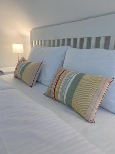 a bed with two pillows on top of it at The View 22 in Cerklje na Gorenjskem