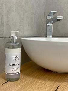a bottle of liquid soap sitting next to a sink at The View 22 in Cerklje na Gorenjskem