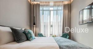 Giường trong phòng chung tại Hotel Vitruvio