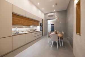 a kitchen with a table and chairs and a sink at Luxurious & Spacious Central Residence with Balcony in Budapest