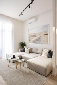 a white living room with a couch and a table at Luxurious & Spacious Central Residence with Balcony in Budapest