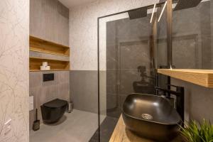a bathroom with a sink and a glass shower at Luxurious & Spacious Central Residence with Balcony in Budapest +37 photos