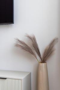 a vase with feathers sitting next to a wall at Luxurious & Spacious Central Residence with Balcony in Budapest