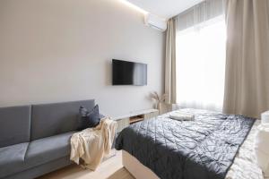 a bedroom with a bed and a couch at Luxurious & Spacious Central Residence with Balcony in Budapest