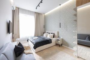 a bedroom with a bed and a glass wall at Luxurious & Spacious Central Residence with Balcony in Budapest