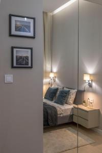 a bedroom with a bed and a glass wall at Luxurious & Spacious Central Residence with Balcony in Budapest