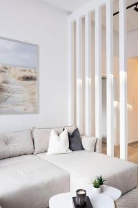 a white living room with a white couch at Luxurious & Spacious Central Residence with Balcony in Budapest