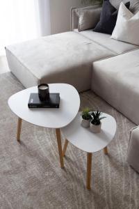 a white coffee table next to a white couch at Luxurious & Spacious Central Residence with Balcony in Budapest