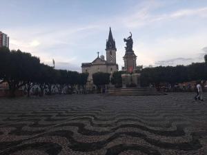 a statue in front of a building with a clock tower at Joia Centro Manaus - Apartamento in Manaus