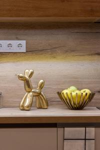 a couple of gold figurines sitting on a shelf at Luxurious & Spacious Central Residence with Balcony in Budapest